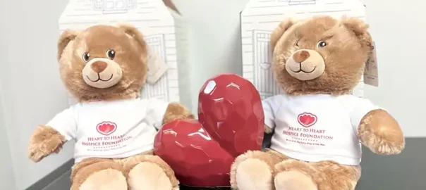 Two HtoHH Foundation teddy bears with a heart